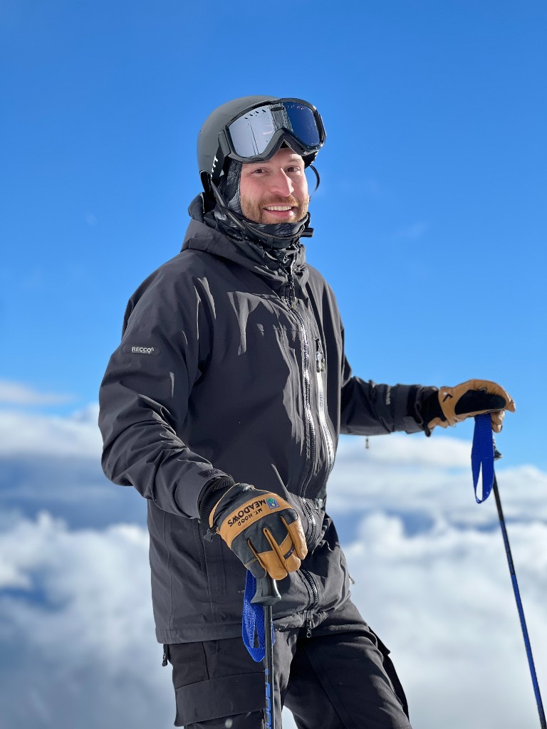Daniel Wild, founder of Wildish Adventure Tours, in ski gear above the clouds